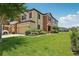 Charming two-story townhome with a well-maintained lawn, beautiful landscaping, and an attached garage at 11617 Crowned Sparrow Ln, Tampa, FL 33626