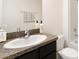Bathroom featuring a granite countertop vanity and a white toilet and shower at 1217 Cape Chestnut Pl, Ruskin, FL 33570