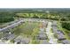 Aerial view capturing a suburban neighborhood with lush green spaces, ponds and homes at 12189 Nouveau Ave, Spring Hill, FL 34610