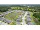 Aerial view showcasing the community, surrounded by lush greenery and a serene pond at 12189 Nouveau Ave, Spring Hill, FL 34610