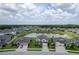 Stunning aerial view of homes surrounding a peaceful pond, reflecting a harmonious community at 12189 Nouveau Ave, Spring Hill, FL 34610