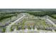Aerial view of a residential community featuring well-maintained homes, ponds, lush greenery, and scenic surroundings at 12189 Nouveau Ave, Spring Hill, FL 34610