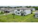 Large backyard with a covered patio, lush lawn, and white exterior at 12189 Nouveau Ave, Spring Hill, FL 34610