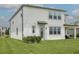 Well-maintained backyard with green grass, covered patio, and manicured landscaping at 12189 Nouveau Ave, Spring Hill, FL 34610