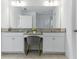 Bathroom vanity featuring double sinks, granite countertops, and bright lighting at 12189 Nouveau Ave, Spring Hill, FL 34610