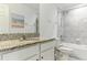 Bright bathroom featuring granite countertop, tub, shower, and tile surround at 12189 Nouveau Ave, Spring Hill, FL 34610