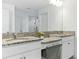 Bright bathroom vanity featuring double sinks, granite countertops, and ample lighting at 12189 Nouveau Ave, Spring Hill, FL 34610