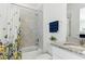 Bright bathroom featuring shower and bath combination with stylish curtain and granite vanity at 12189 Nouveau Ave, Spring Hill, FL 34610