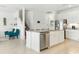Open kitchen featuring white cabinets, a granite island with seating, and stainless steel appliances at 12189 Nouveau Ave, Spring Hill, FL 34610