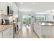 Open-concept kitchen with granite countertops, stainless steel appliances, and an eat-in area with backyard views at 12189 Nouveau Ave, Spring Hill, FL 34610
