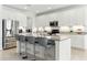 Bright kitchen with a granite island, stainless appliances, and seating for three at 12189 Nouveau Ave, Spring Hill, FL 34610