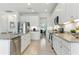 Well-lit kitchen with stainless steel appliances, granite countertops, and white cabinetry at 12189 Nouveau Ave, Spring Hill, FL 34610