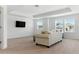 Bright living room with a comfy couch and large TV and many windows at 12189 Nouveau Ave, Spring Hill, FL 34610