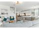 Open-concept living space showcasing a comfortable couch, kitchen, and staircase at 12189 Nouveau Ave, Spring Hill, FL 34610