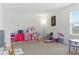 Spacious playroom with lots of space for playing and a large sunny window at 12189 Nouveau Ave, Spring Hill, FL 34610