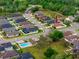 Suburban aerial view of houses in a lush green community, with an arrow indicating the property's location at 12337 Rose Haven Blvd, New Port Richey, FL 34654