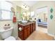 Bathroom features a double vanity, decorative mirror, and views into the bedroom at 12337 Rose Haven Blvd, New Port Richey, FL 34654