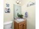 Charming half-bathroom features beach decor, vanity, and a toilet at 12337 Rose Haven Blvd, New Port Richey, FL 34654