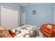 Cozy bedroom features closet, door, plush bed, and comfy chair, perfect for relaxation at 12337 Rose Haven Blvd, New Port Richey, FL 34654