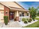 Inviting front porch with brick accents, lovely landscaping, and a cozy seating area at 12337 Rose Haven Blvd, New Port Richey, FL 34654