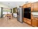 Kitchen with stainless steel appliances, oak cabinets, and adjoining breakfast nook at 12337 Rose Haven Blvd, New Port Richey, FL 34654