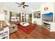 Bright living room featuring hardwood floors, neutral paint, and comfortable seating at 12337 Rose Haven Blvd, New Port Richey, FL 34654