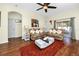 Open living room showcasing hardwood floors, cozy sofas, and natural light at 12337 Rose Haven Blvd, New Port Richey, FL 34654
