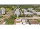 The aerial photo of the neighborhood features many homes, buildings, and a golf course in the background at 1269 Drew St, Clearwater, FL 33755