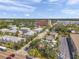 The aerial shot reveals the area around the building, including nearby residential areas, schools, and shopping centers at 1269 Drew St, Clearwater, FL 33755