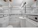 Charming bathroom features classic black and white tile, tub-shower with glass door and classic vanity at 1269 Drew St, Clearwater, FL 33755