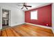 Bedroom with hardwood floors, freshly painted accent wall, and natural light at 1269 Drew St, Clearwater, FL 33755
