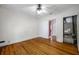 A bedroom featuring hardwood floors, a ceiling fan, and two closets at 1269 Drew St, Clearwater, FL 33755