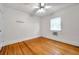A bright bedroom featuring hardwood floors, a ceiling fan, and a window air conditioner at 1269 Drew St, Clearwater, FL 33755