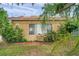 Charming house with terra cotta roof, red trim and mature plants in a desirable location at 1269 Drew St, Clearwater, FL 33755