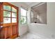 Foyer featuring tile floor, dark wooden door, and view into the living room at 1269 Drew St, Clearwater, FL 33755