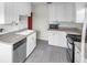 The kitchen has neutral countertops, white cabinets, and a stainless steel dishwasher at 1269 Drew St, Clearwater, FL 33755