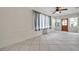 Bright living space with tile floors, multiple windows, and an air conditioning unit at 1269 Drew St, Clearwater, FL 33755