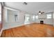 Bright living room with hardwood floors, decorative fireplace, and large windows for natural light at 1269 Drew St, Clearwater, FL 33755