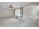 Spacious living room with tile floors, large window, and ceiling fan at 1269 Drew St, Clearwater, FL 33755