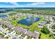 Expansive aerial view of residential community showcasing a serene lake and well-maintained landscaping at 12838 Wildflower Meadow Dr, Riverview, FL 33579