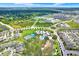 Panoramic aerial view of a vibrant residential community with tennis courts, a pool, and lush landscapes at 12838 Wildflower Meadow Dr, Riverview, FL 33579