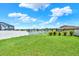 A backyard with green grass, a lake view, and a white fence at 12838 Wildflower Meadow Dr, Riverview, FL 33579