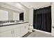 Bathroom featuring double vanity with granite counters and a shower with a black curtain at 12838 Wildflower Meadow Dr, Riverview, FL 33579
