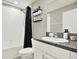 Bathroom featuring granite counters, a white vanity, and a white tiled shower with a black shower curtain at 12838 Wildflower Meadow Dr, Riverview, FL 33579