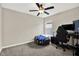 Bedroom featuring a gaming desk, a black gaming chair, and a window at 12838 Wildflower Meadow Dr, Riverview, FL 33579