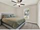 Bedroom with a ceiling fan and a bed covered in green bedding next to a window at 12838 Wildflower Meadow Dr, Riverview, FL 33579