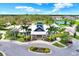 Aerial view of the community clubhouse with palm trees and manicured landscaping, showcasing its appeal at 12838 Wildflower Meadow Dr, Riverview, FL 33579