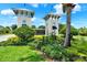 Landscaped entrance to Triple Creek community featuring twin tower structures and lush green foliage at 12838 Wildflower Meadow Dr, Riverview, FL 33579