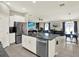 Open-concept kitchen with stainless appliances flowing into the living and dining areas at 12838 Wildflower Meadow Dr, Riverview, FL 33579
