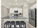 Modern kitchen with stainless steel appliances and a large island with breakfast bar at 12838 Wildflower Meadow Dr, Riverview, FL 33579